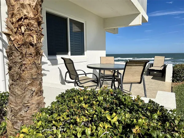 a view of a chairs and table in a patio