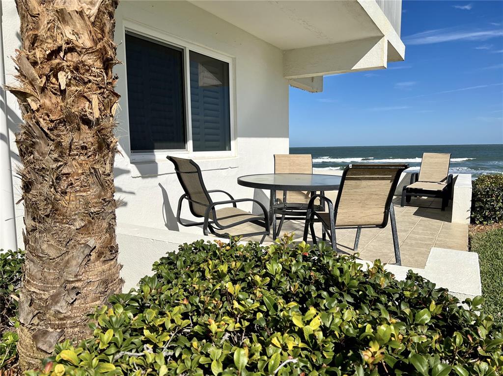 815 Ocean Shore Boulevard, Unit 13 Ormond Beach, FL 32176 - Photo 7 of 17 a view of a chairs and table in a patio