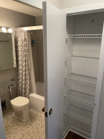 a bathroom with a toilet and a shower