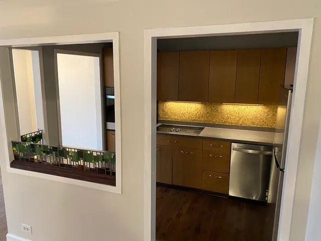 a kitchen with granite countertop white cabinets and black appliances