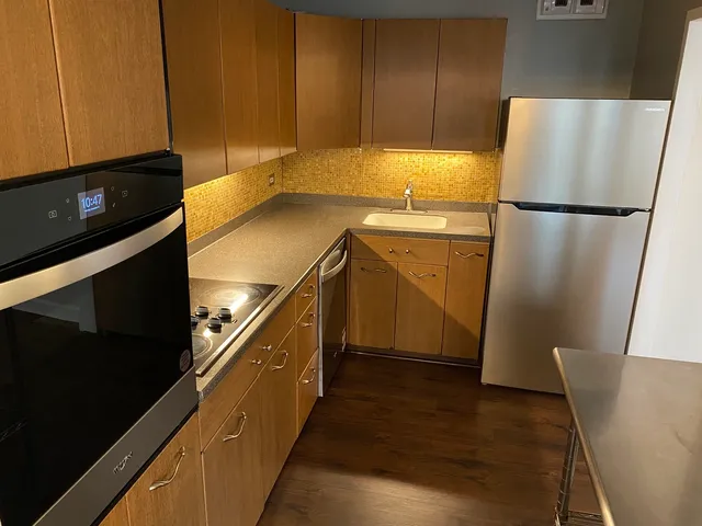 a kitchen with a refrigerator and a stove