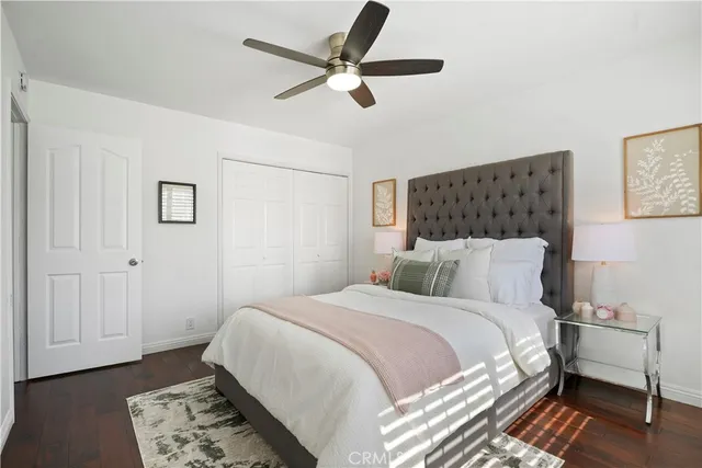 a bedroom with a bed and a painting on the wall