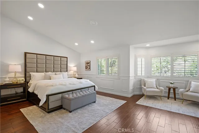 a large bedroom with a bed and large window