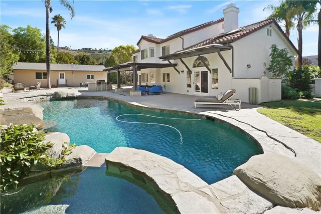 a view of a house with backyard porch and sitting area