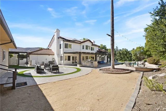 a front view of a house with garden and patio
