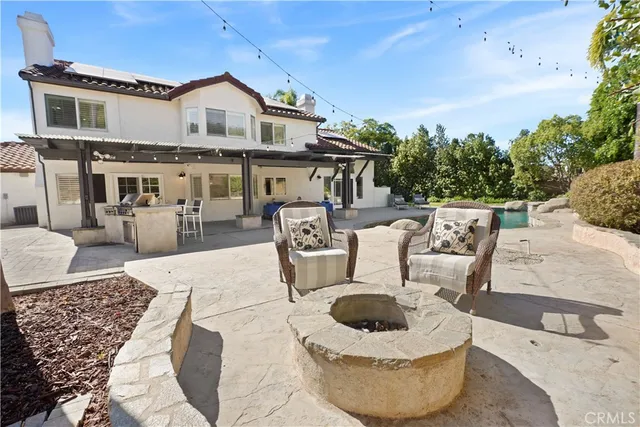 a view of a patio with couches chairs and a potted plant