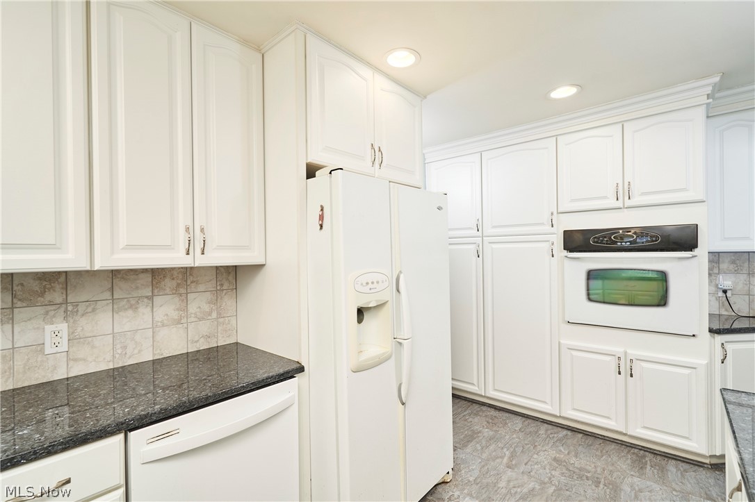 2941 Sweitzer Road Uniontown, OH 44685 - Photo 6 of 16 Kitchen featuring tasteful backsplash, white appliances, white cabinetry, and recessed lighting