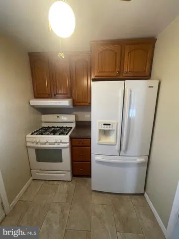 a kitchen with granite countertop wooden cabinets and granite counter tops