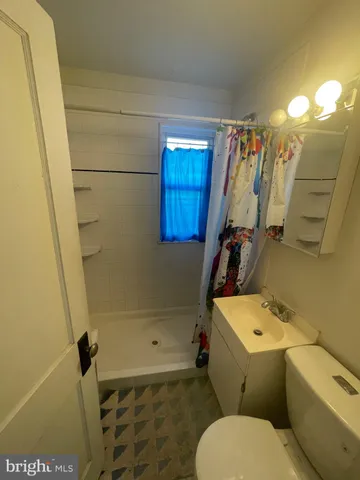 a view of a big room with wooden floor and a ceiling fan