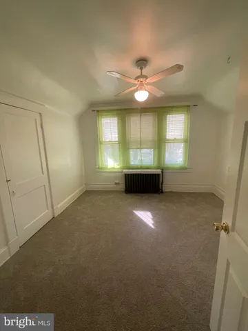 a bathroom with a tub a sink and a window