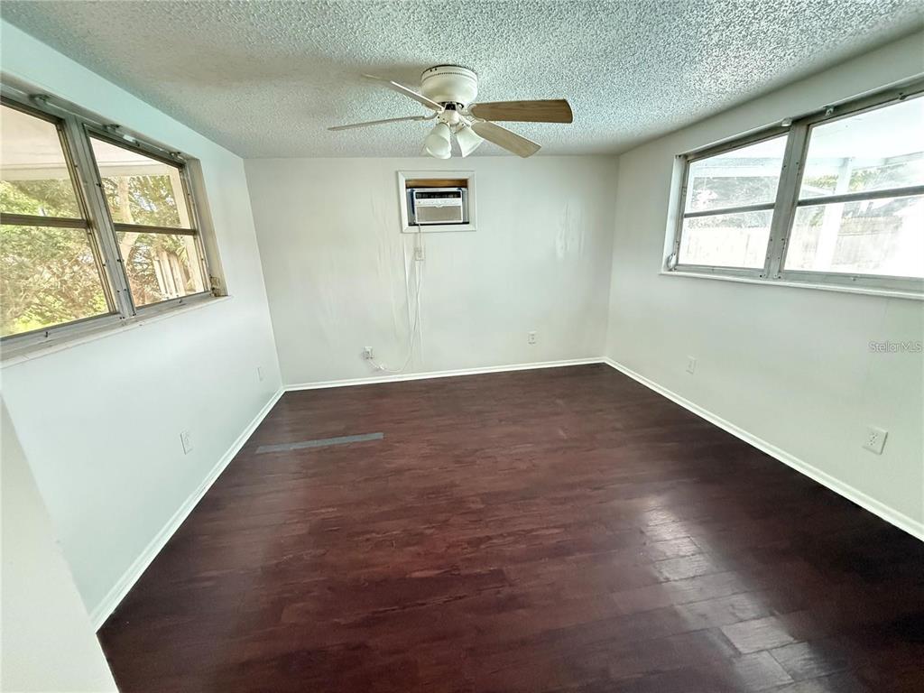 4233 Darlington Road Holiday, FL 34691 - Photo 8 of 25 an empty room with windows and ceiling fan