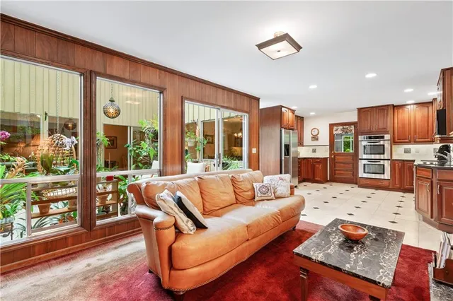 a kitchen with granite countertop wooden cabinets a stove a oven and a window