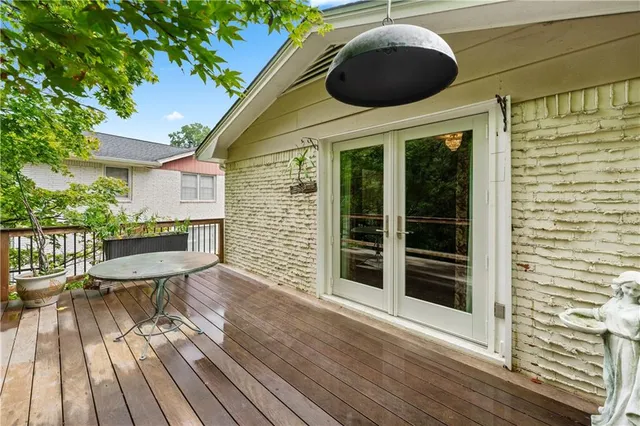 a bathroom with a granite countertop sink a toilet a mirror and shower