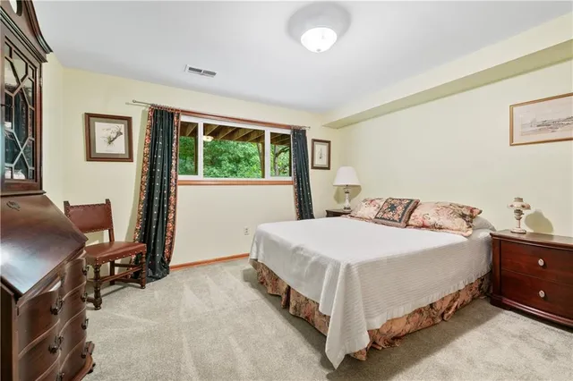 a bedroom with a bed and a desk