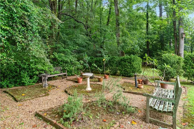 a view of a house with swimming pool and sitting area