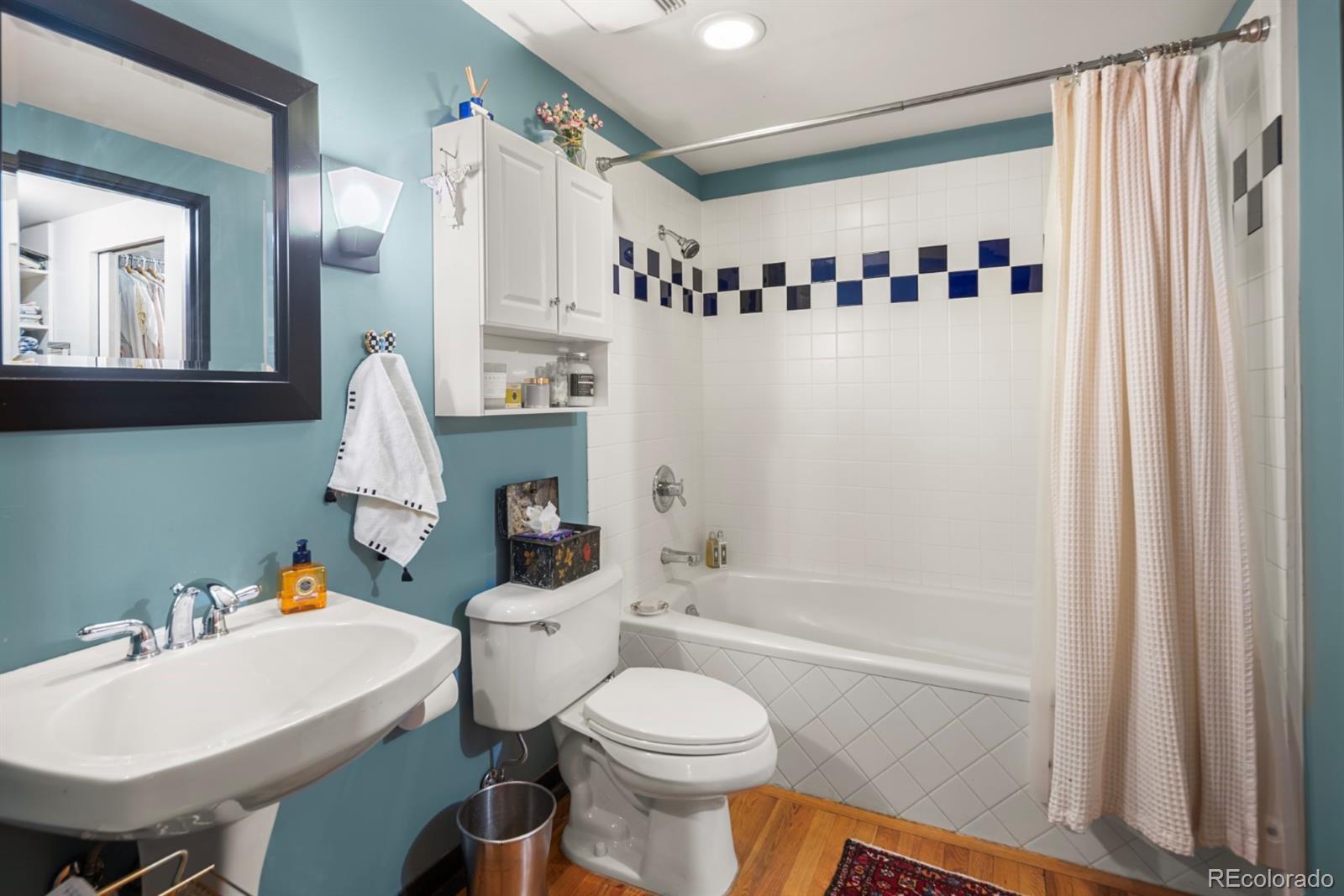 2000 Little Raven Street, Unit 1B Denver, CO 80202 - Photo 26 of 39 a bathroom with a sink toilet and shower