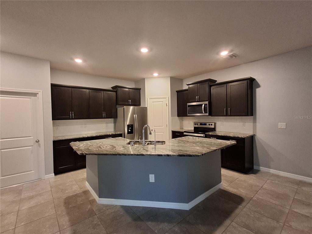 7891 Stonebrook Circle Wesley Chapel, FL 33545 - Photo 11 of 39 a view of kitchen with stainless steel appliances granite countertop counter top and stove