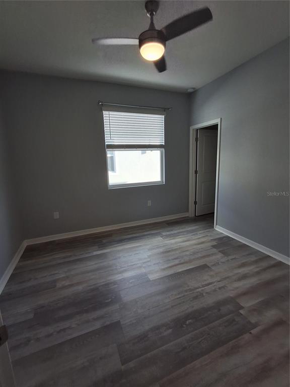 7891 Stonebrook Circle Wesley Chapel, FL 33545 - Photo 17 of 39 an empty room with wooden floor and windows