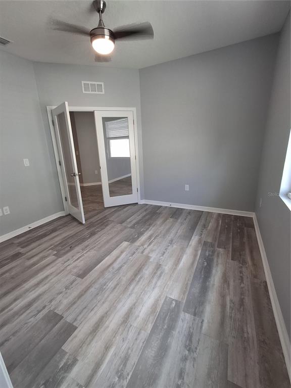7891 Stonebrook Circle Wesley Chapel, FL 33545 - Photo 18 of 39 wooden floor in an empty room with a window