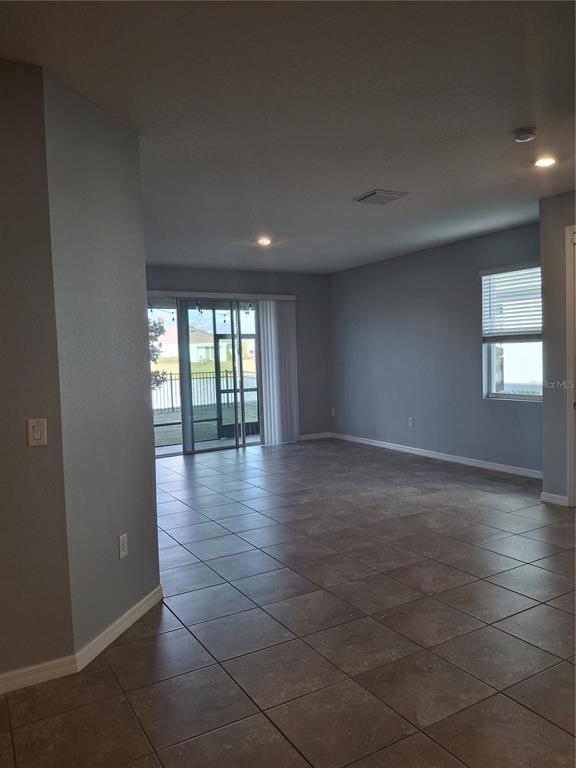 7891 Stonebrook Circle Wesley Chapel, FL 33545 - Photo 22 of 39 an empty room with large windows