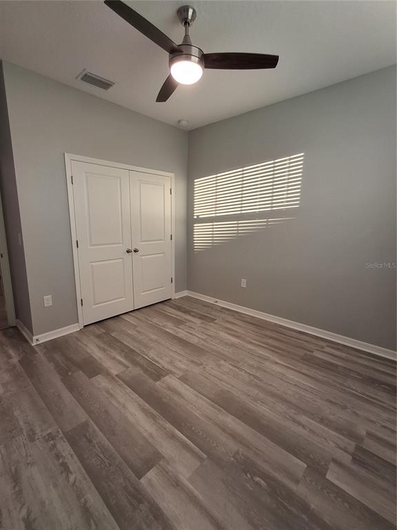 7891 Stonebrook Circle Wesley Chapel, FL 33545 - Photo 28 of 39 a view of empty room with wooden floor and fan
