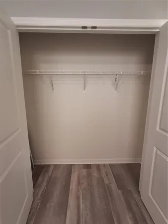 a bathroom with a granite countertop sink a toilet and a mirror