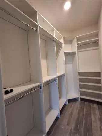 a bed sitting in a kitchen next to a window