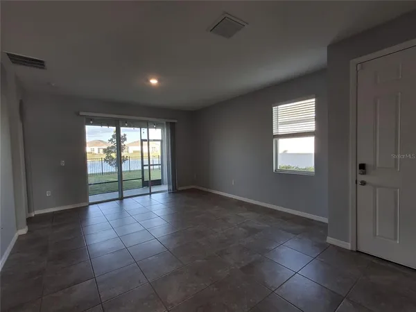 a large kitchen with stainless steel appliances a sink a stove top oven and cabinets