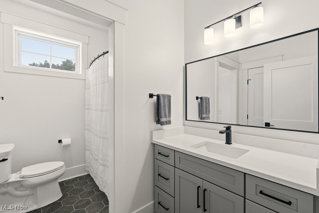 2941 Southern Road Richfield, OH 44286 - Photo 36 of 50 Full bath featuring curtained shower, vanity, and dark tile patterned flooring