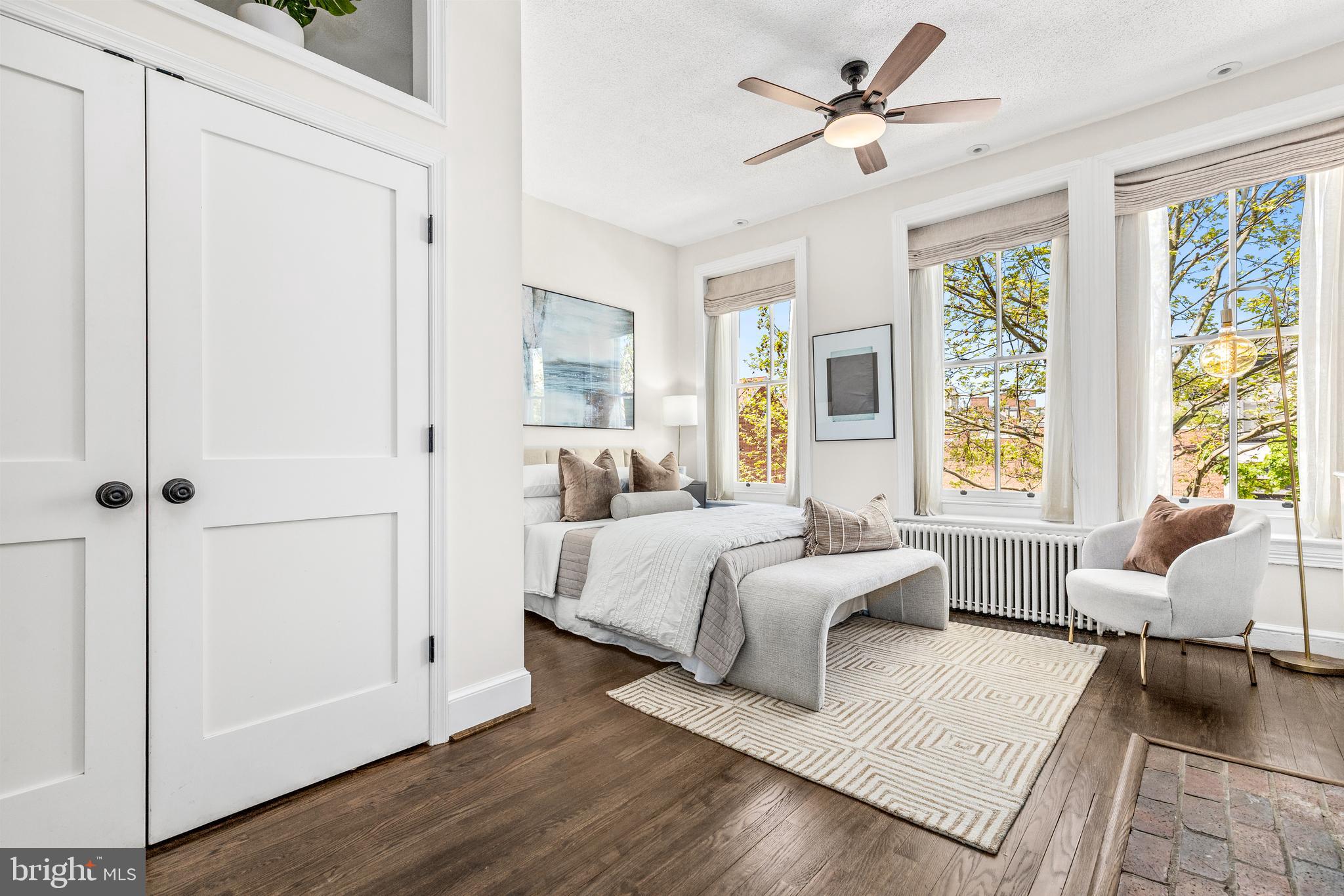 1213 29th Street Northwest Washington, DC 20007 - Photo 12 of 31 a spacious bedroom with a bed and a couch