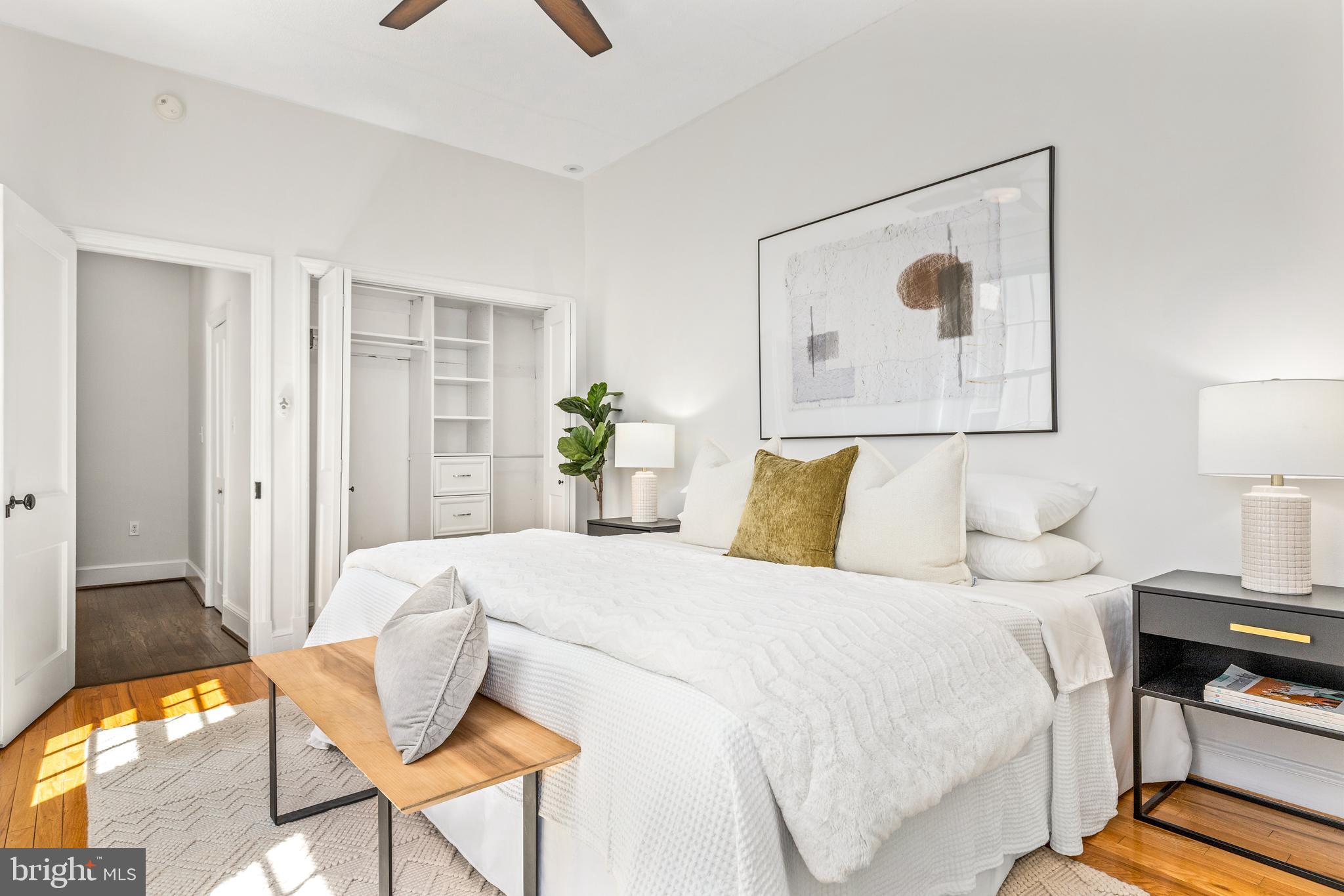 1213 29th Street Northwest Washington, DC 20007 - Photo 17 of 31 a bedroom with a bed and a lamp on table