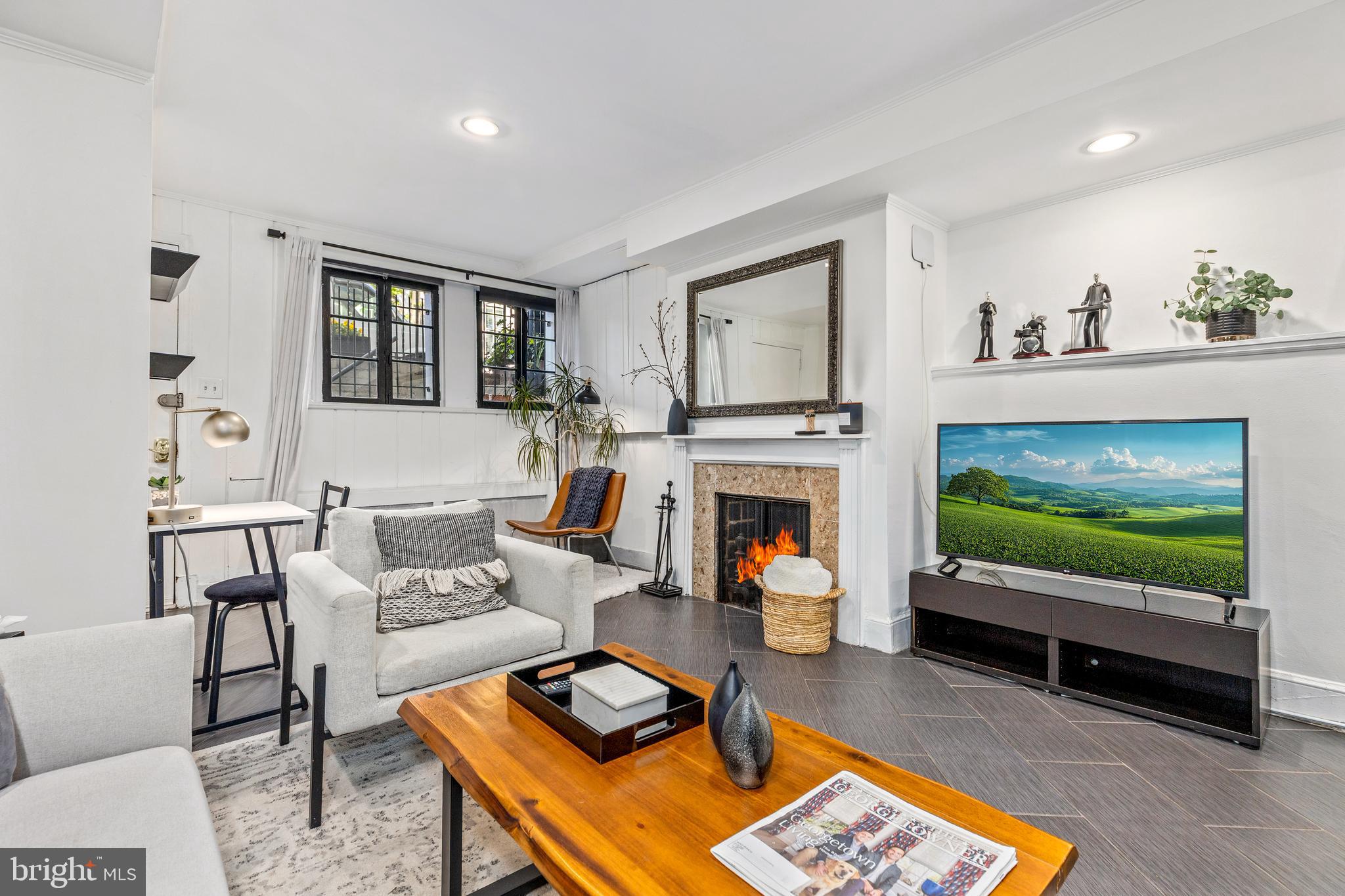 1213 29th Street Northwest Washington, DC 20007 - Photo 21 of 31 a living room with furniture a flat screen tv and a fireplace