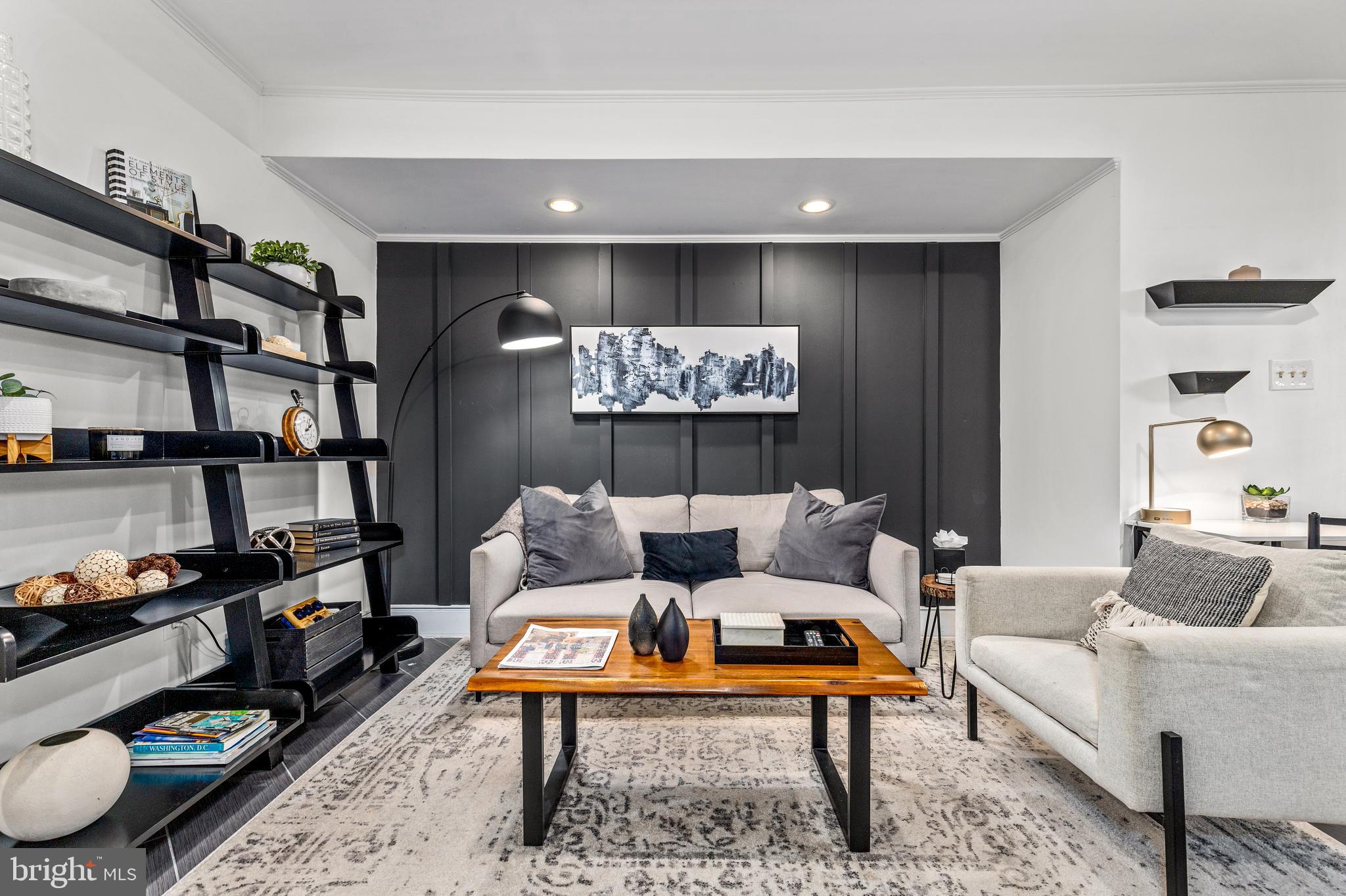 1213 29th Street Northwest Washington, DC 20007 - Photo 22 of 31 a living room with furniture a rug and a bookshelf