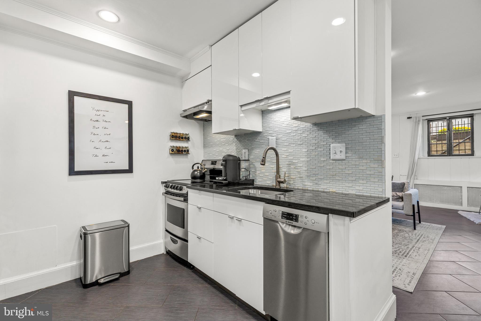 1213 29th Street Northwest Washington, DC 20007 - Photo 24 of 31 a kitchen with stainless steel appliances granite countertop a sink and cabinets