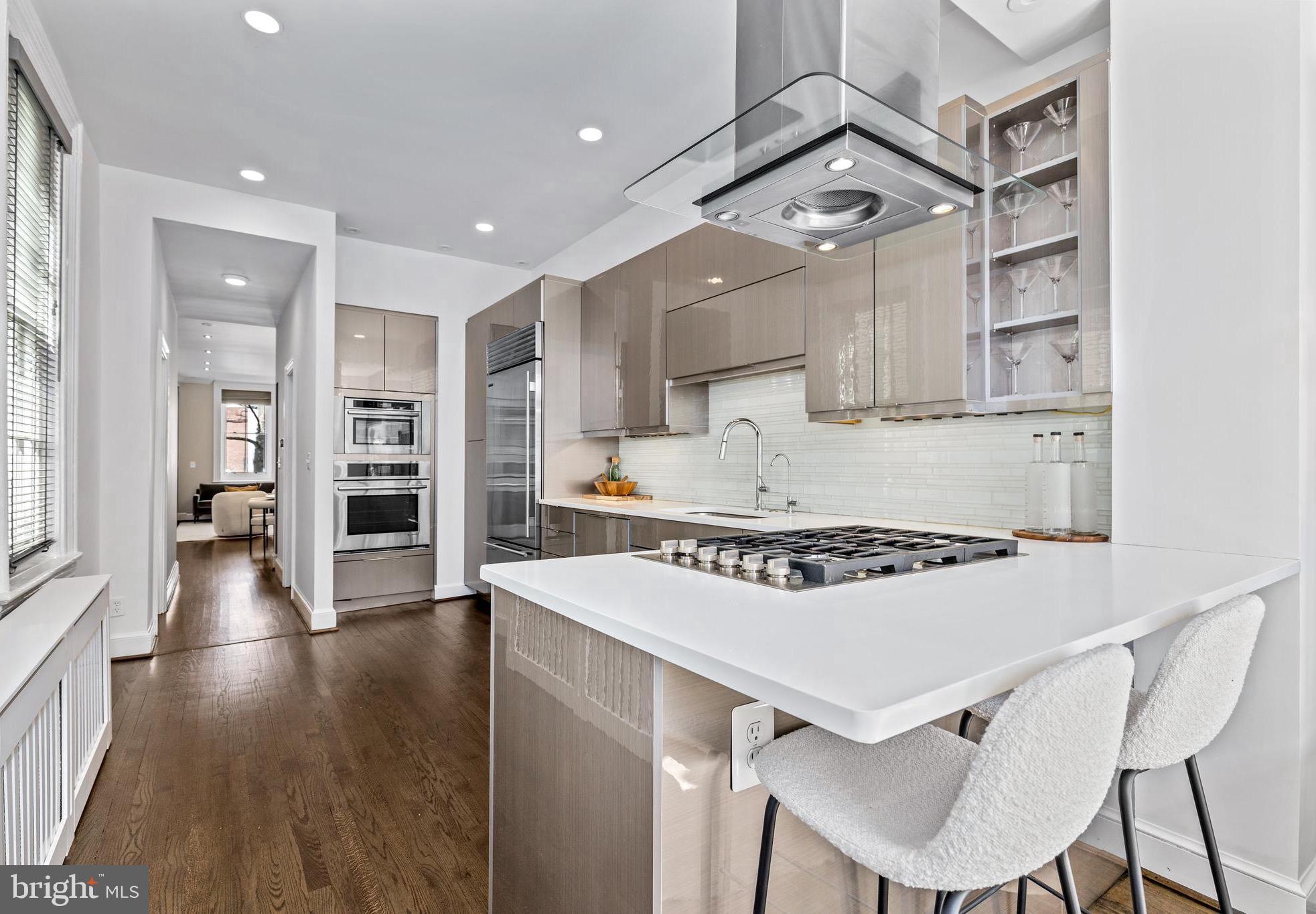 1213 29th Street Northwest Washington, DC 20007 - Photo 10 of 31 a kitchen with a stove a refrigerator and wooden floor