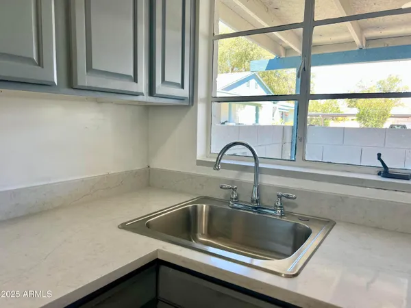 a kitchen with a sink and cabinets