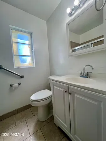 a bathroom with a sink toilet and a mirror