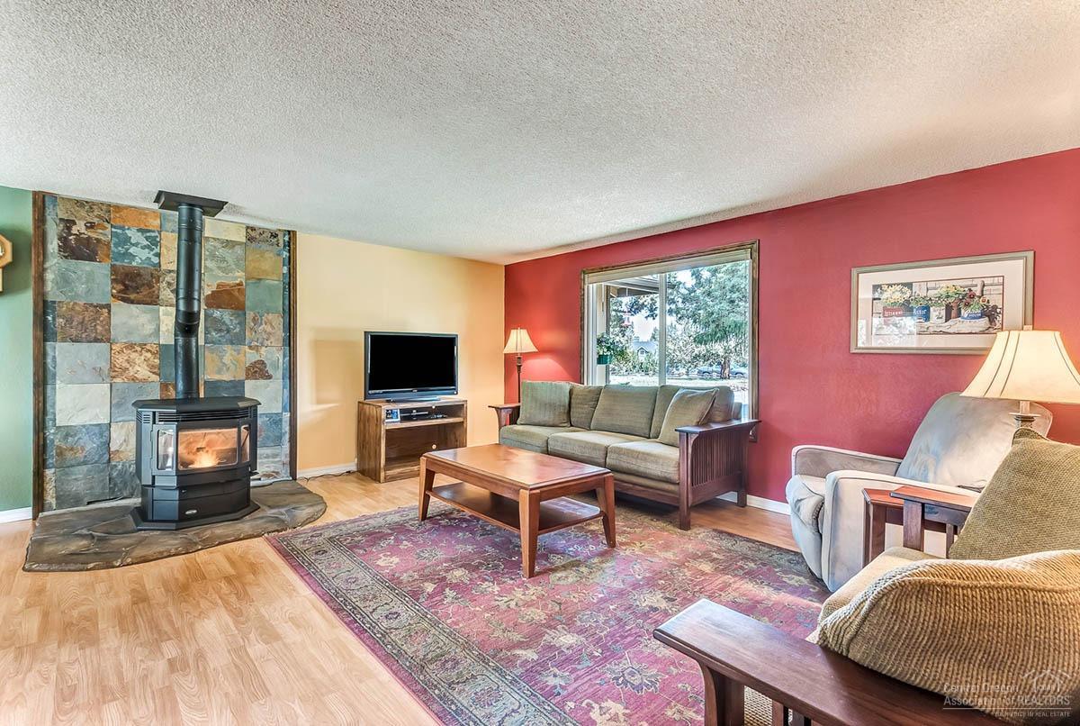 64729 Sylvan Loop Bend, OR 97701 - Photo 4 of 25 a living room with furniture fireplace and a flat screen tv