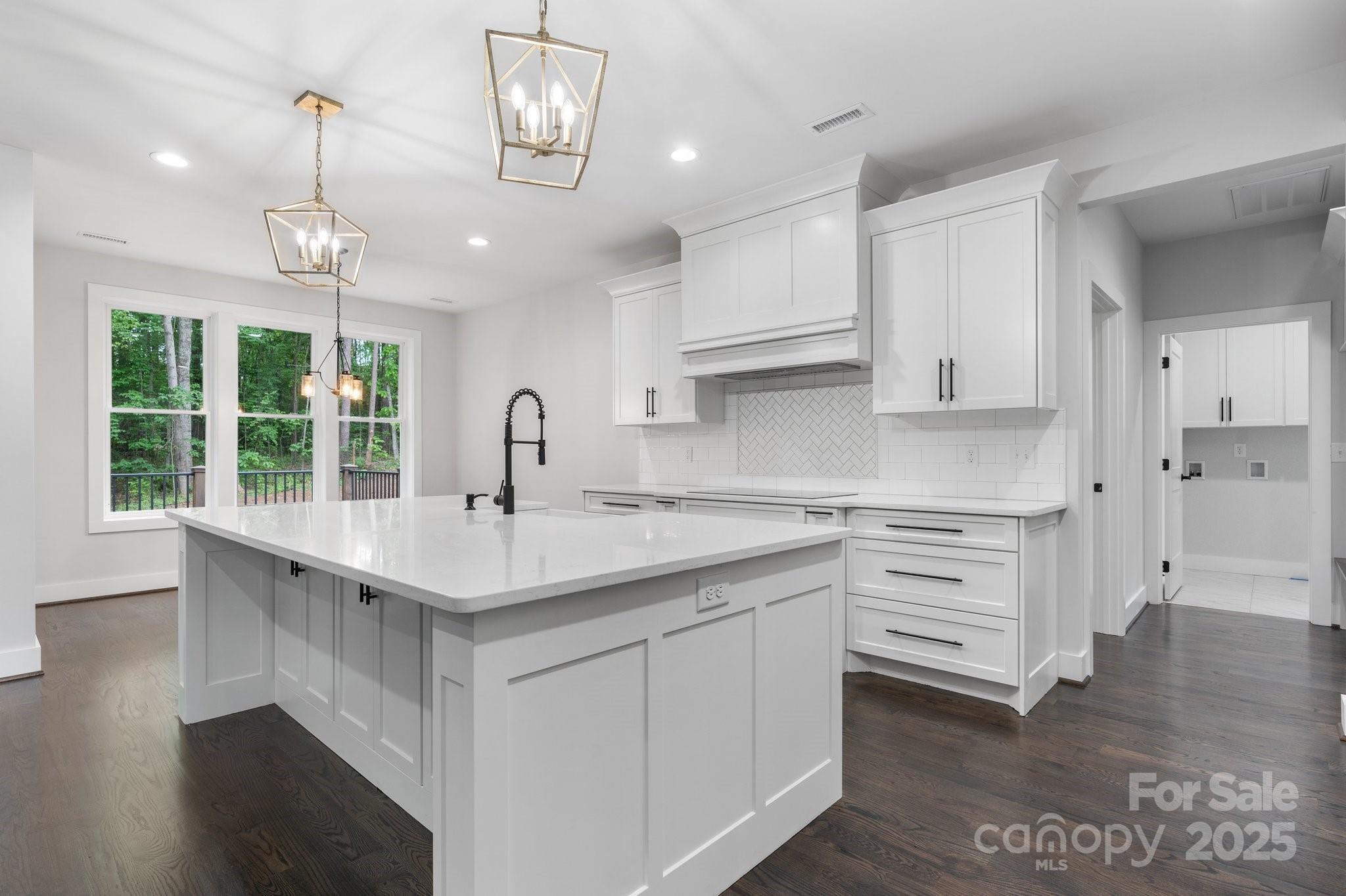 3732 Whitney Drive Northeast Hickory, NC 28601 - Photo 13 of 48 a kitchen with white cabinets appliances and a chandelier