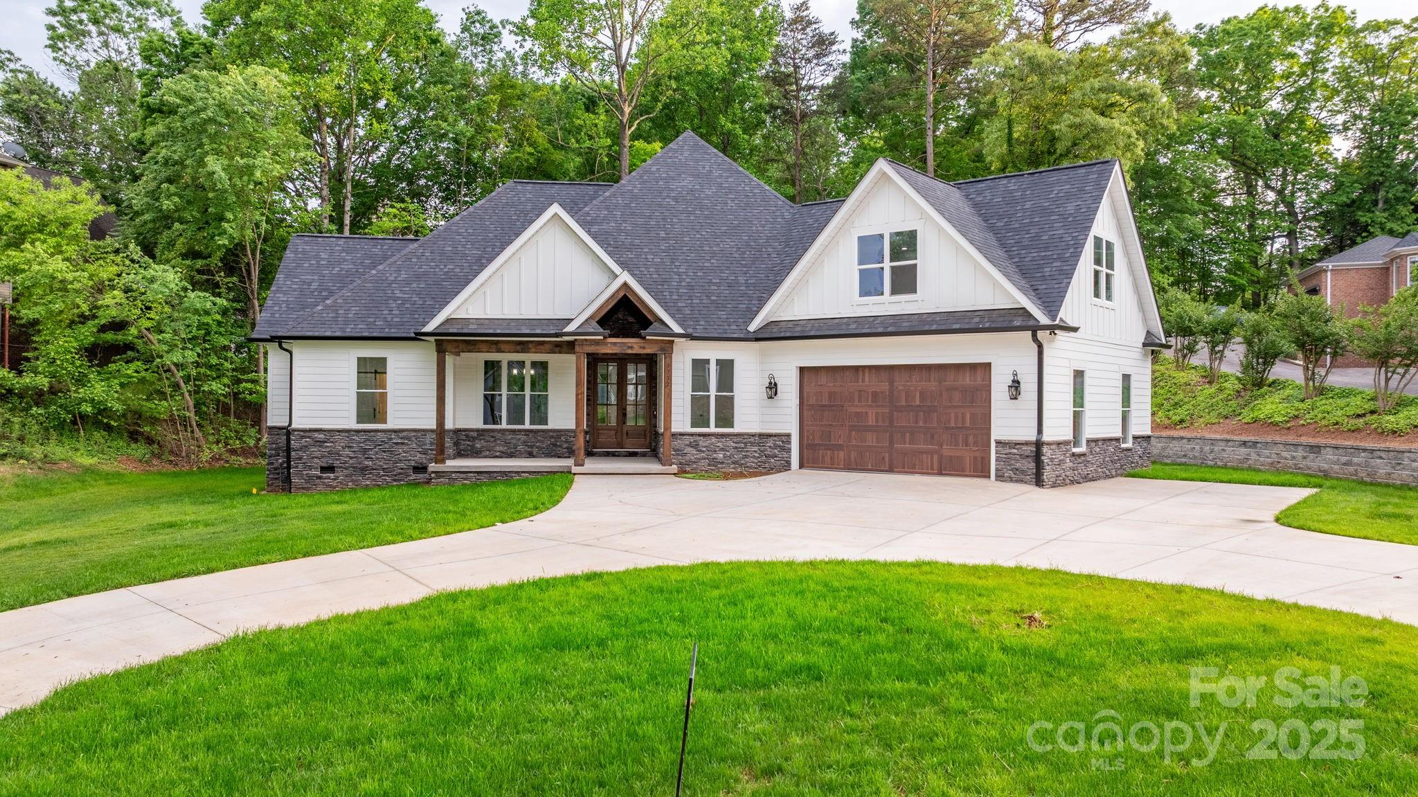 3732 Whitney Drive Northeast Hickory, NC 28601 - Photo 2 of 48 a front view of a house with a garden and yard