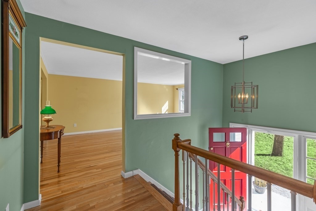 3 Bacon Road Framingham, MA 01701 - Photo 4 of 42 a view of a hallway with wooden floor and windows