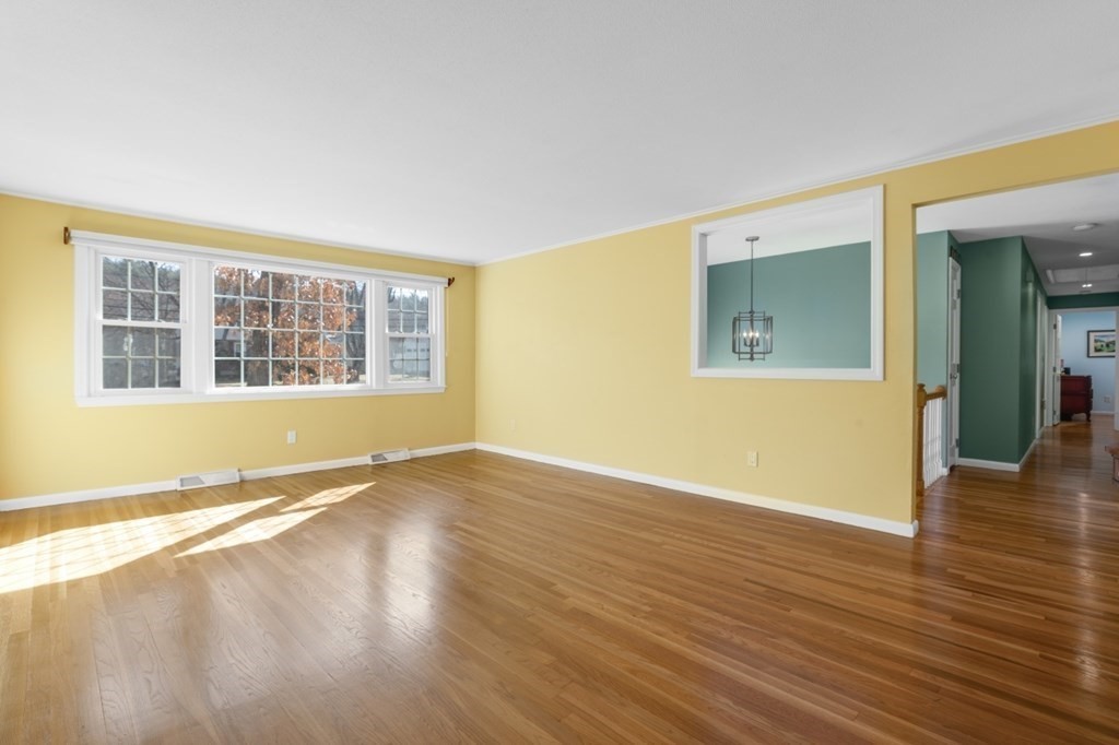 3 Bacon Road Framingham, MA 01701 - Photo 5 of 42 a view of an empty room with wooden floor and a window
