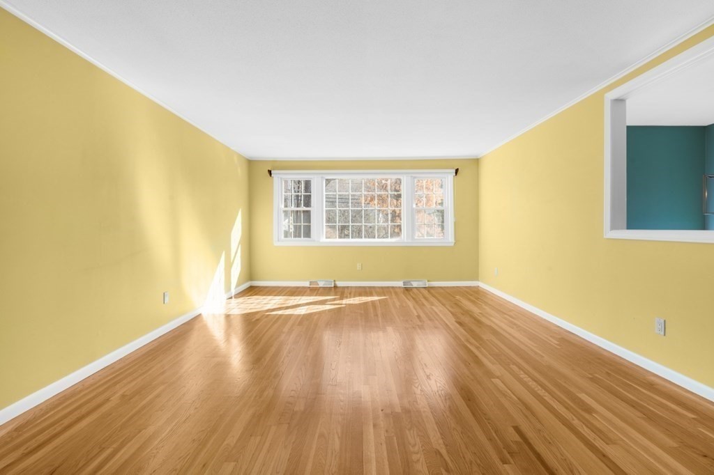3 Bacon Road Framingham, MA 01701 - Photo 6 of 42 a view of an empty room with wooden floor and a window