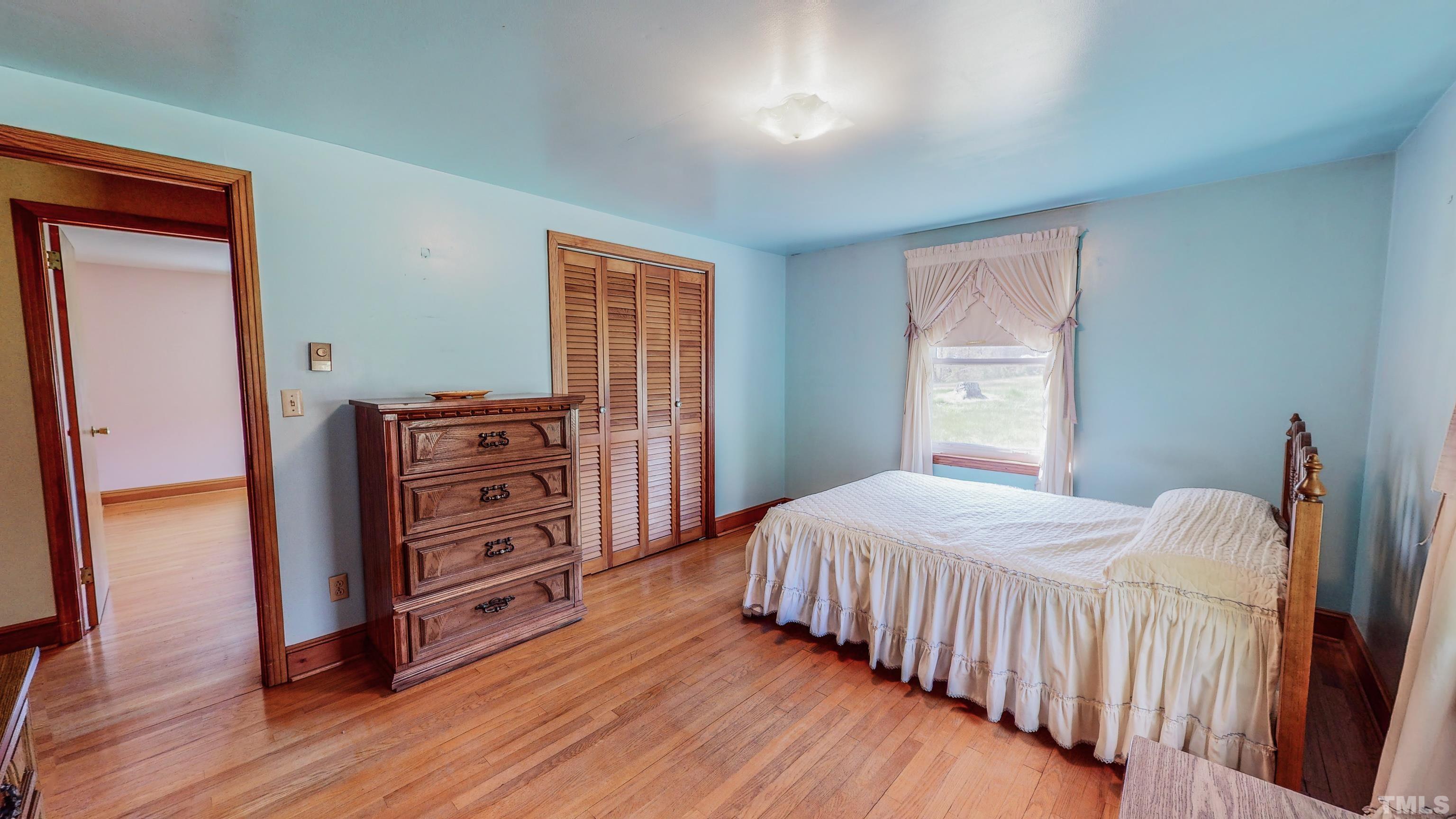 9639 Boston Road Roxboro, NC 27574 - Photo 21 of 52 a bedroom with a bed and wooden floor