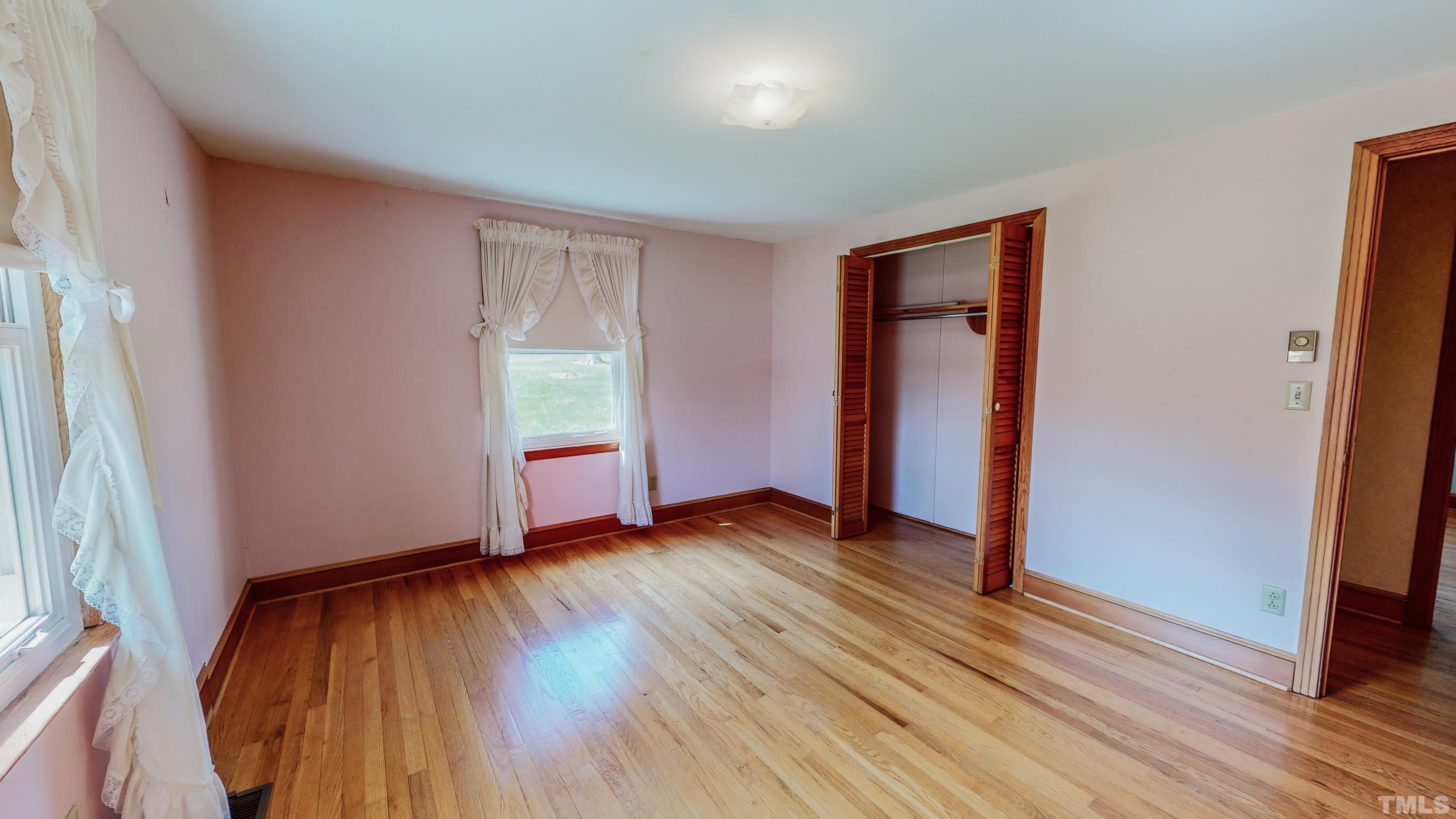 9639 Boston Road Roxboro, NC 27574 - Photo 22 of 52 an empty room with wooden floor and windows