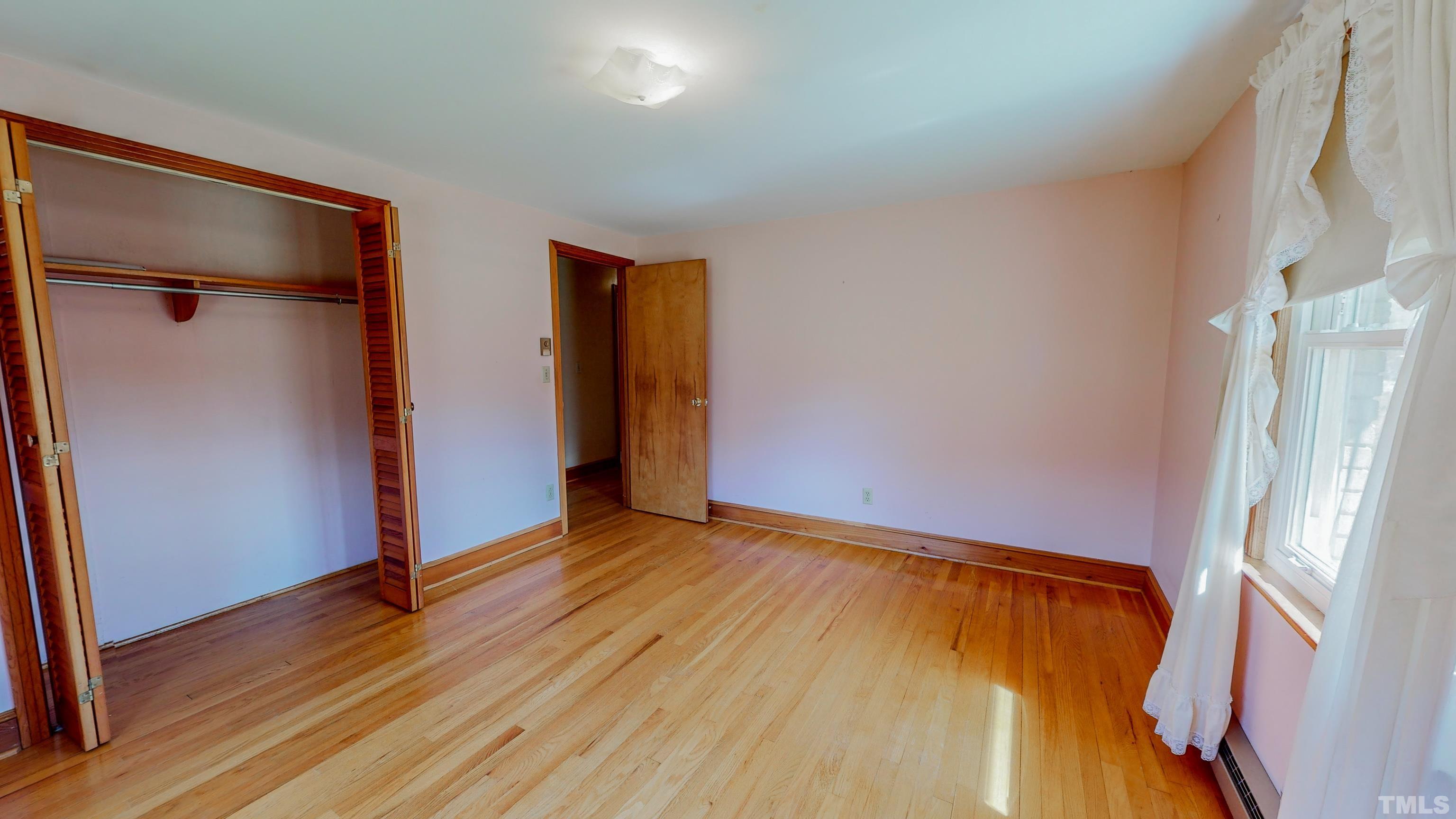 9639 Boston Road Roxboro, NC 27574 - Photo 23 of 52 a view of an empty room with wooden floor and a window
