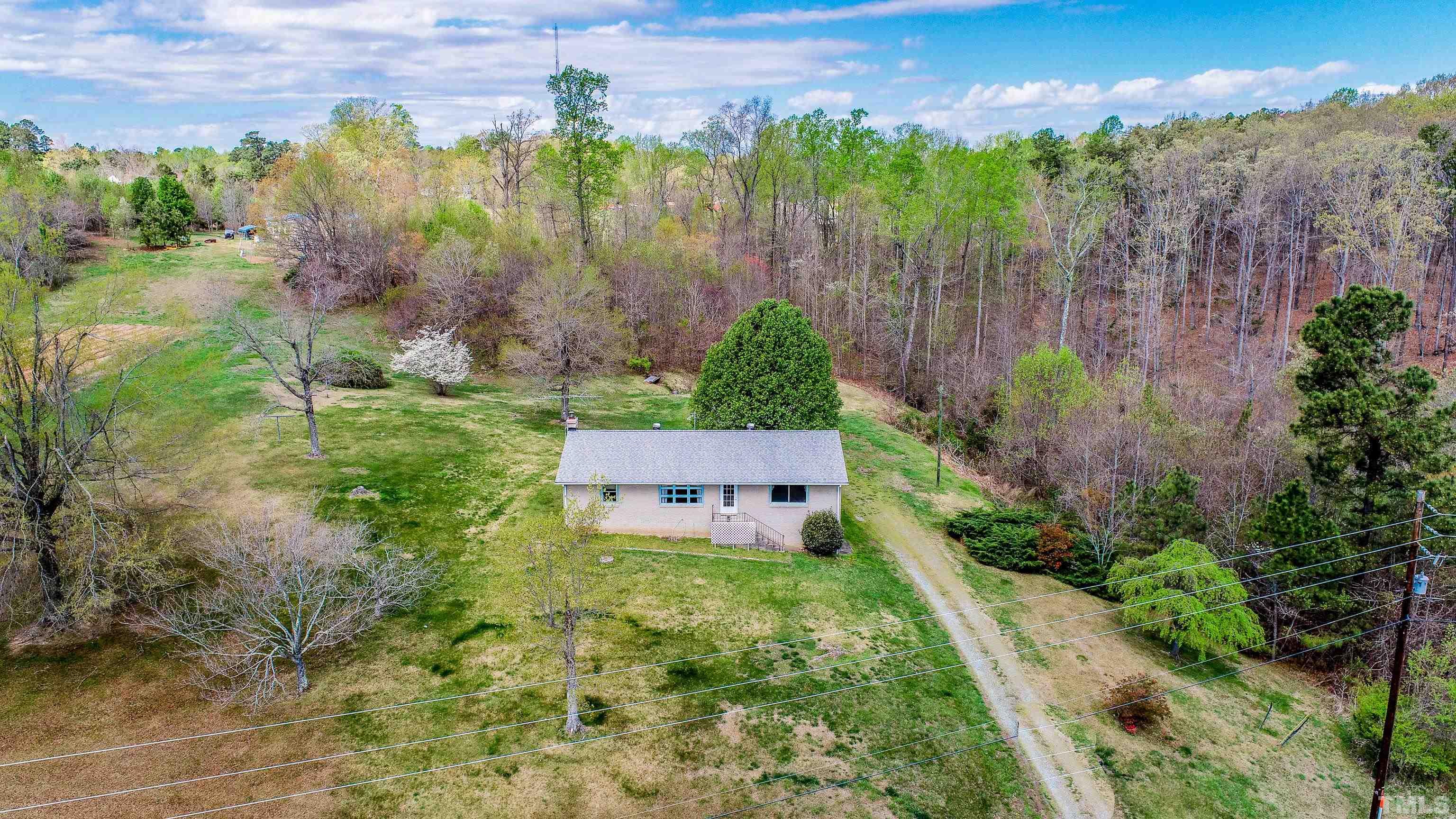 9639 Boston Road Roxboro, NC 27574 - Photo 42 of 52 a view of a garden with a building in the background