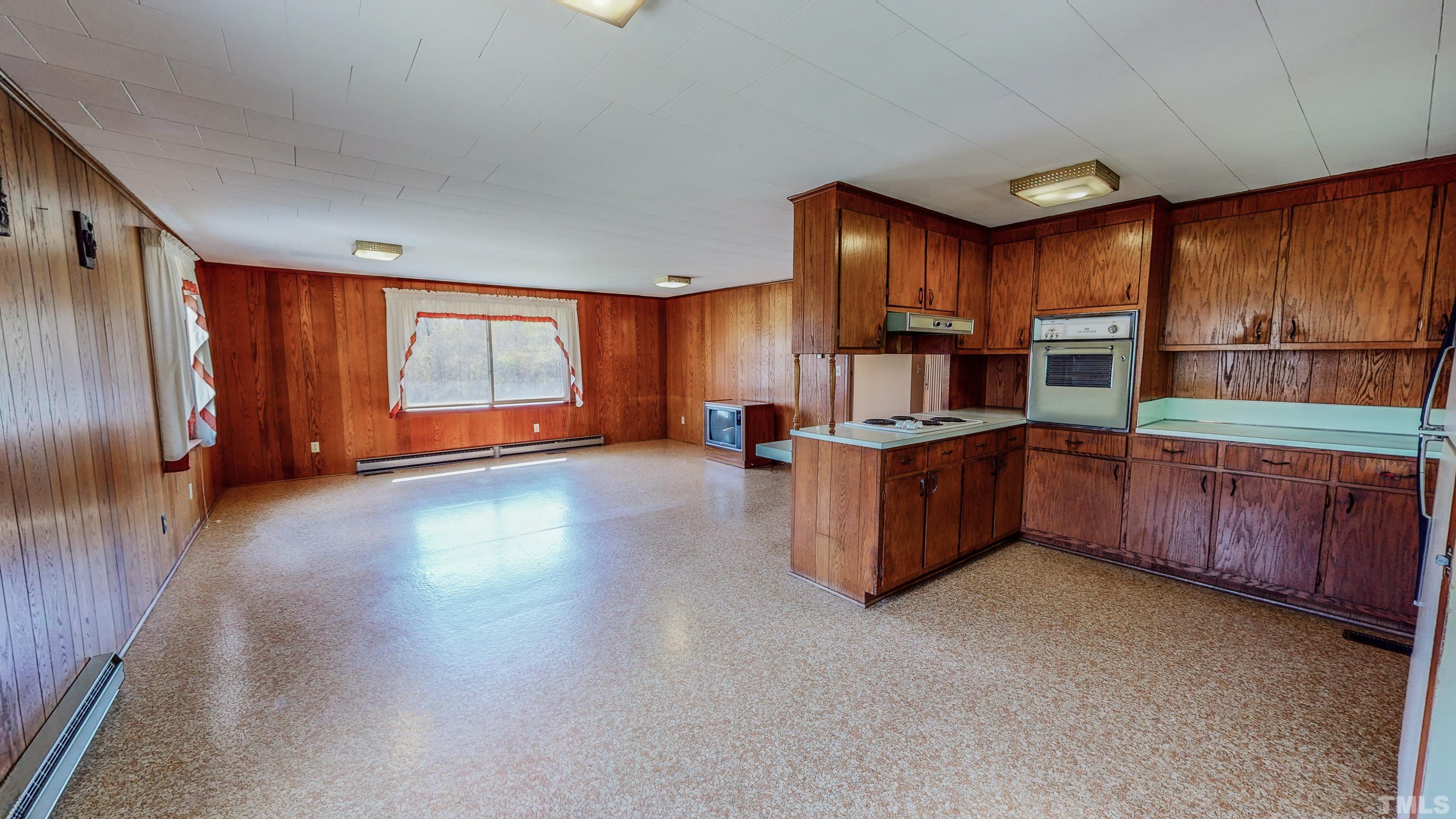 9639 Boston Road Roxboro, NC 27574 - Photo 6 of 52 a kitchen with stainless steel appliances wooden cabinets a stove top oven a sink and dishwasher