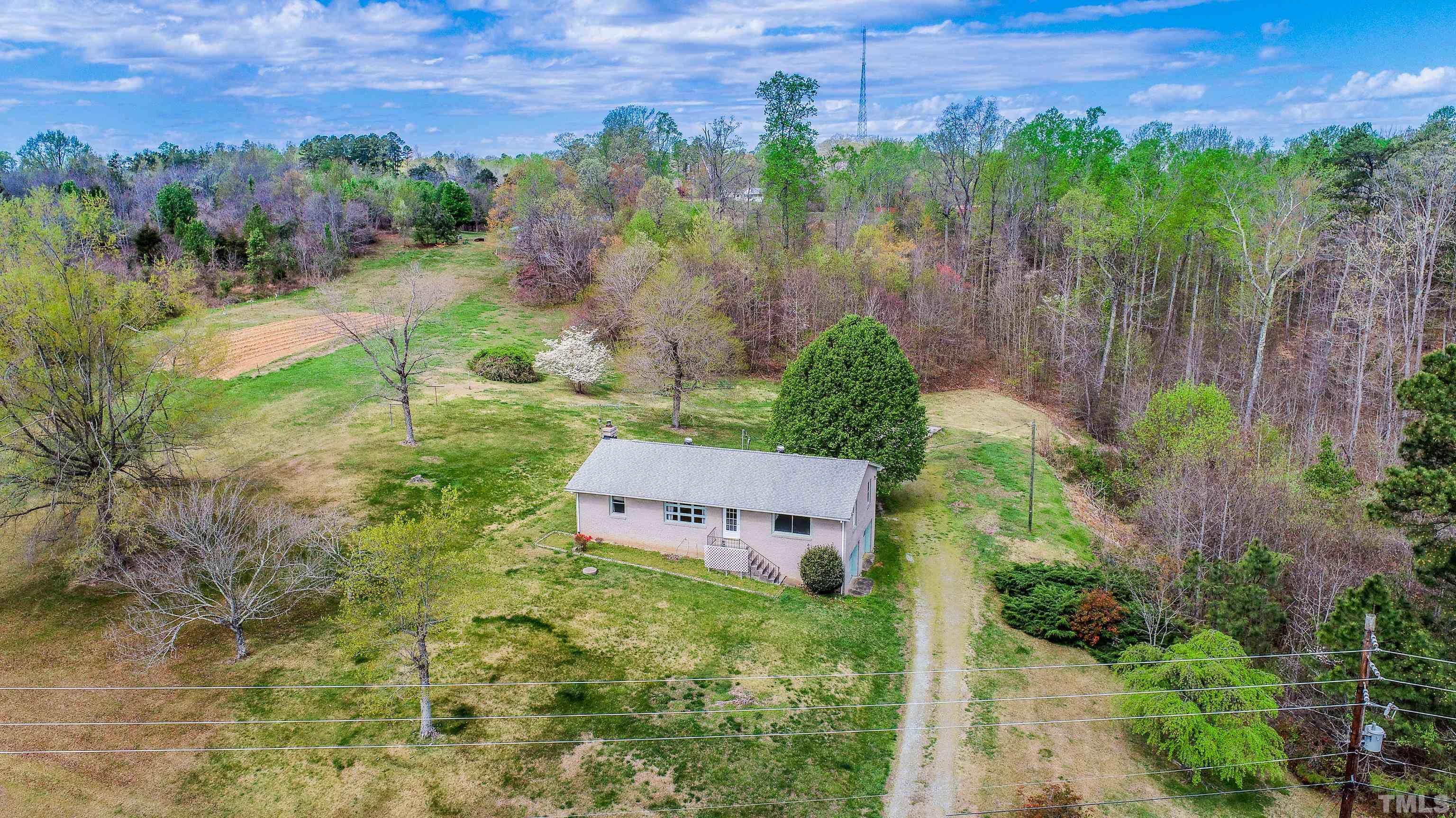 9639 Boston Road Roxboro, NC 27574 - Photo 9 of 52 a view of a house with a yard and a garden