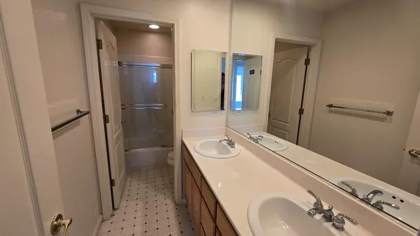 a bathroom with a sink double vanity and a mirror